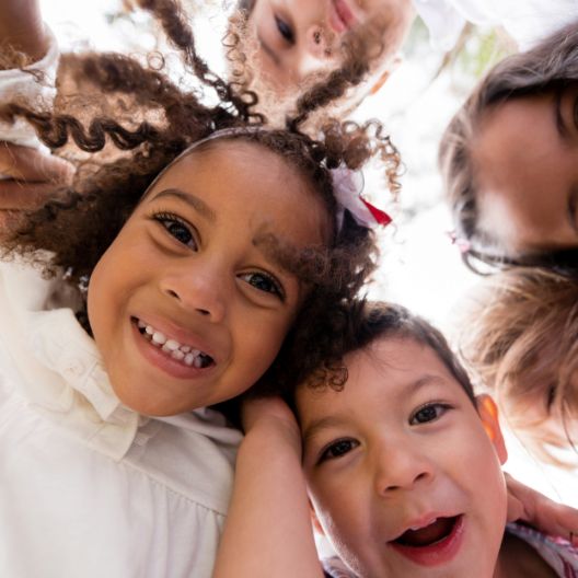 Hyperbiotics Probiotics for kids. A group of children looking down.