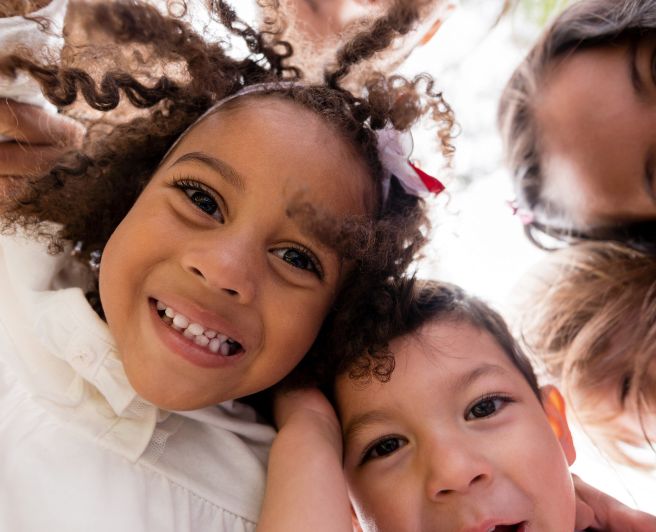 Hyperbiotics Probiotics for kids. A group of children looking down.