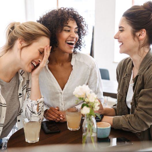 Hyperbiotics probiotics formulated specifically for women. A group of women sitting together at a table.