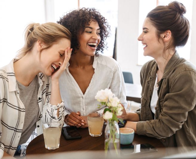 Hyperbiotics probiotics formulated specifically for women. A group of women sitting together at a table.